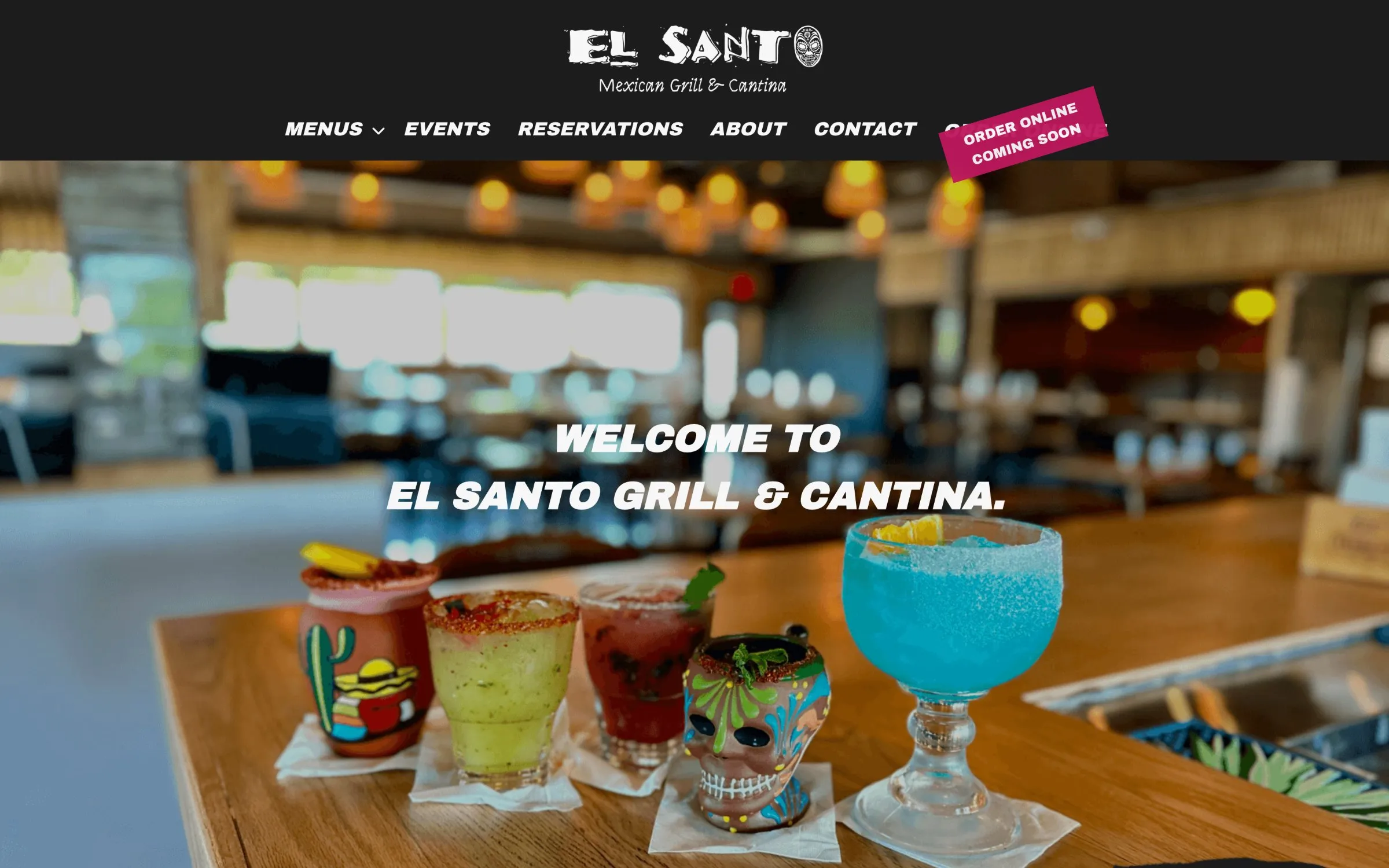 El Santo homepage: Welcome to El Santo Grill & Cantina over a row of margaritas